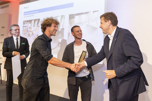 Mann gratuliert Gewinner, schüttelt ihm die Hand